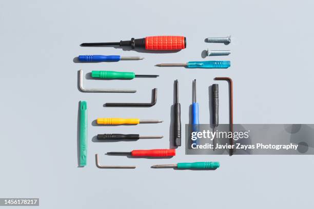 working tools arranged on gray background - gereedschap stockfoto's en -beelden