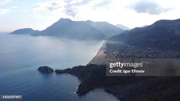 cirali village on the mediterranean coast with a long beach from a drone - kemer stock-fotos und bilder