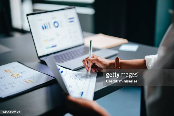 close up photo of woman hands writing report on a paper  in the cafe - money markets imagens e fotografias de stock
