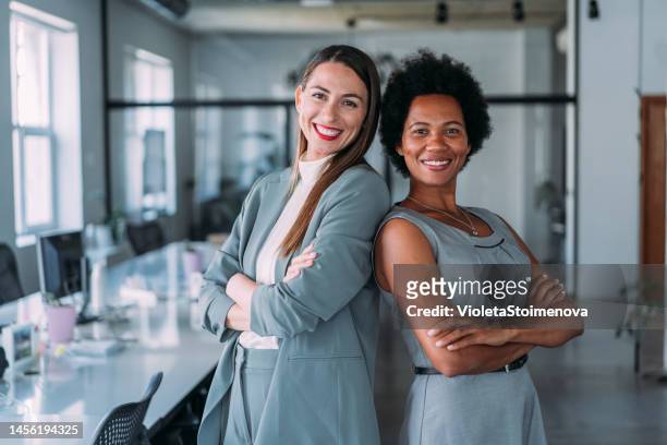 exitoso equipo empresarial femenino. - dos mujeres fotografías e imágenes de stock