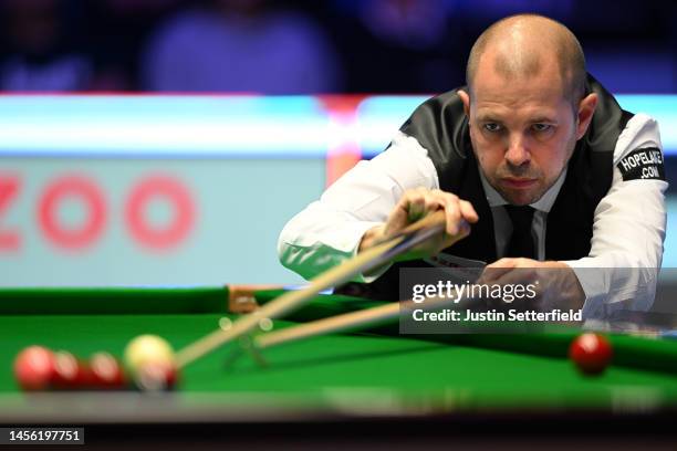 Barry Hawkins of England plays a shot with the rest during their Qaurter Final match against Judd Trump of England during Day Six of the Cazoo...