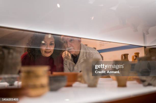 attractive old couple on a date at the museum - sarcophagus stock pictures, royalty-free photos & images