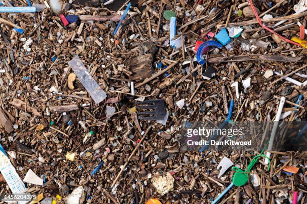 Plastic and other detritus including small plastic pellets known as nurdles line the shoreline of the Thames estuary on January 13, 2023 in Cliffe,...