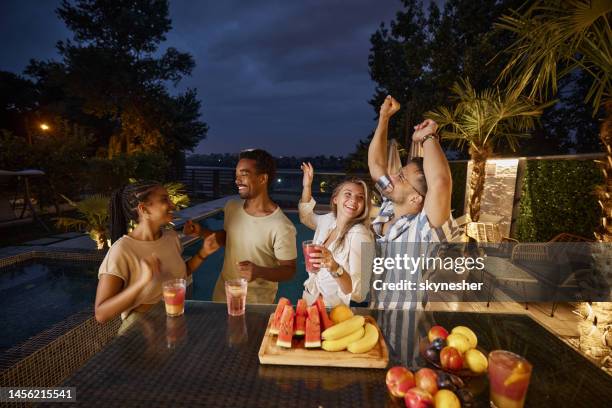 happy couples dancing on a night party in the backyard. - pool party night stock pictures, royalty-free photos & images