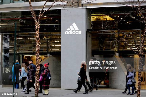 People make their way past an Adidas Store on January 13, 2023 in New York City. Adidas has lost a court case against New York fashion designer Thom...