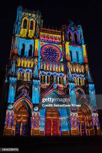 colourful projection on the facade of the cathedral, amiens, france - laser light show stock pictures, royalty-free photos & images