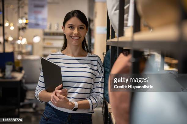 happy saleswoman working at a furniture store - portrait department store stock pictures, royalty-free photos & images