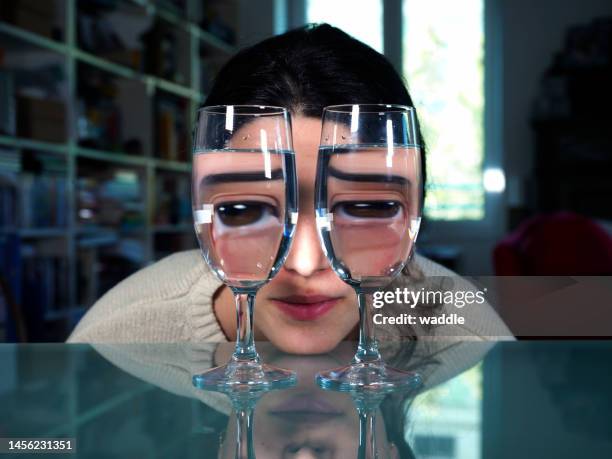 alcohol warps reality - glases stock pictures, royalty-free photos & images