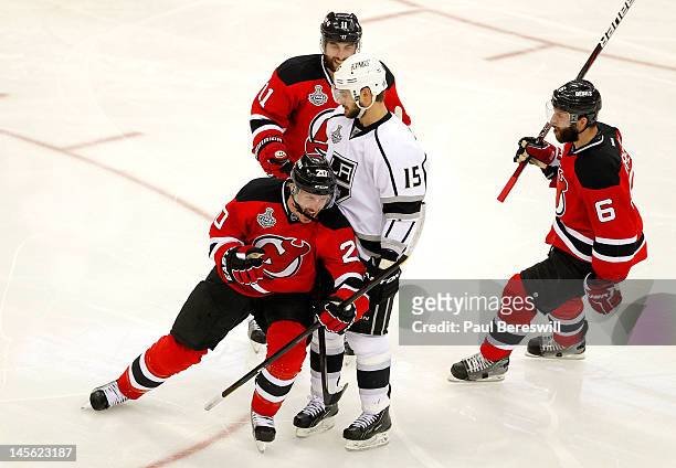 Ryan Carter of the New Jersey Devils celebrates after scoring a goal in the third period as Stephen Gionta and Andy Greene look on with Brad...