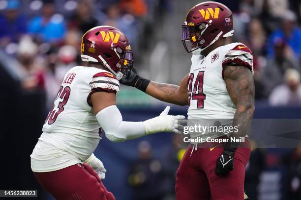 Jonathan Allen of the Washington Commanders celebrates with Daron Payne against the Houston Texans at NRG Stadium on November 20, 2022 in Houston,...