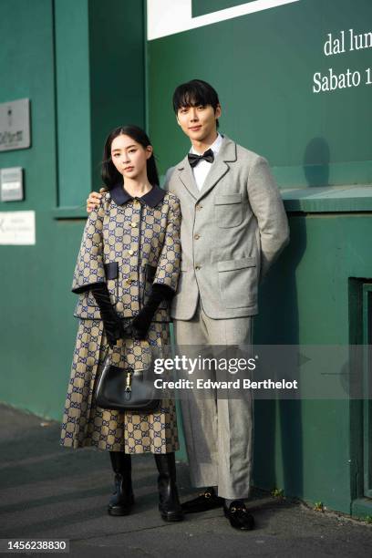 Song Se Ra wears a brown with navy blue monogram embroidered pattern cloak jacket from Gucci, a matching brown with navy blue monogram embroidered...