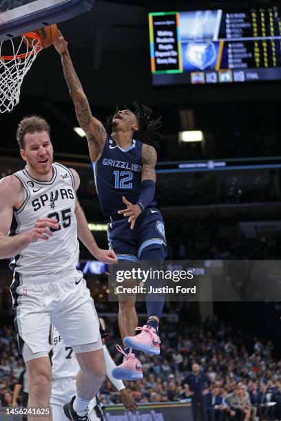 Ja Morant of the Memphis Grizzlies goes to the basket against Jakob Poeltl of the San Antonio Spurs during the game at FedExForum on January 11, 2023...
