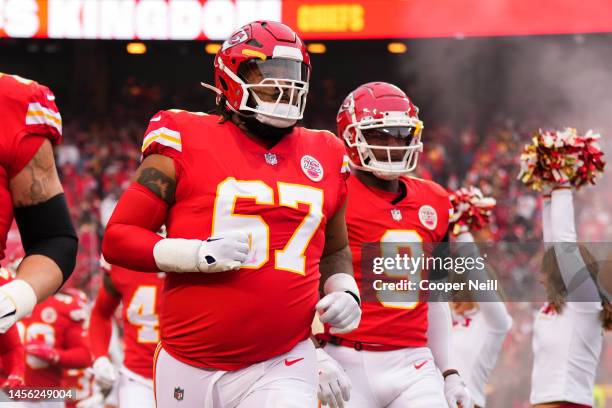 Lucas Niang of the Kansas City Chiefs runs onto the field during introductions against the Los Angeles Rams at GEHA Field at Arrowhead Stadium on...