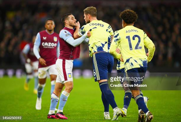 Liam Cooper of Leeds United clashes with Emi Buendia of Aston Villa during the Premier League match between Aston Villa and Leeds United at Villa...
