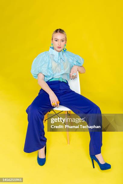 fashionable woman dresses in blue - bright colour chair stock pictures, royalty-free photos & images