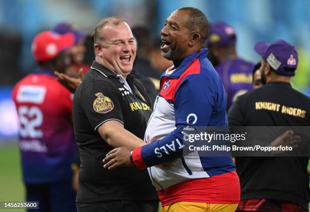 Wayne Bentley of Abu Dhabi Knight Riders laughs with Phil Simmons of Dubai Capitals after the first match between Dubai Capitals and Abu Dhabi Knight...