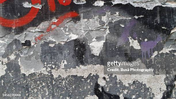 colorful detail of cracking plaster wall - graffiti wall stock-fotos und bilder
