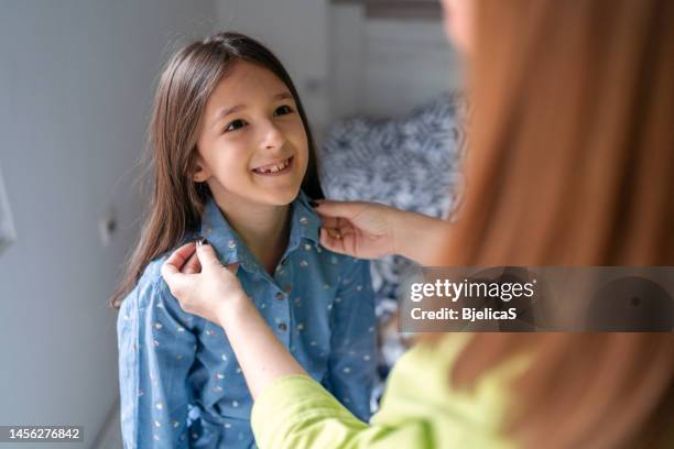 mother preparing daughter for first day of school - s dear mama event stock pictures, royalty-free photos & images