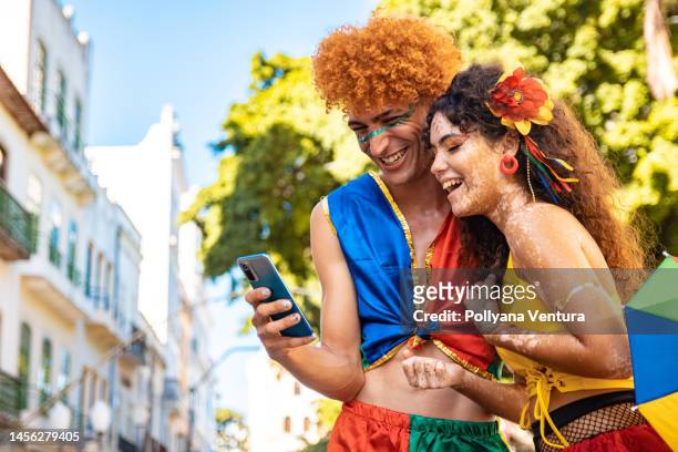 tourists on video call at brazil carnival - carnivale stock pictures, royalty-free photos & images
