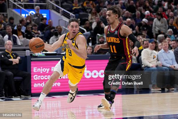 McConnell of the Indiana Pacers dribbles the ball while guarded by Trae Young of the Atlanta Hawks in the second quarter of the game at Gainbridge...