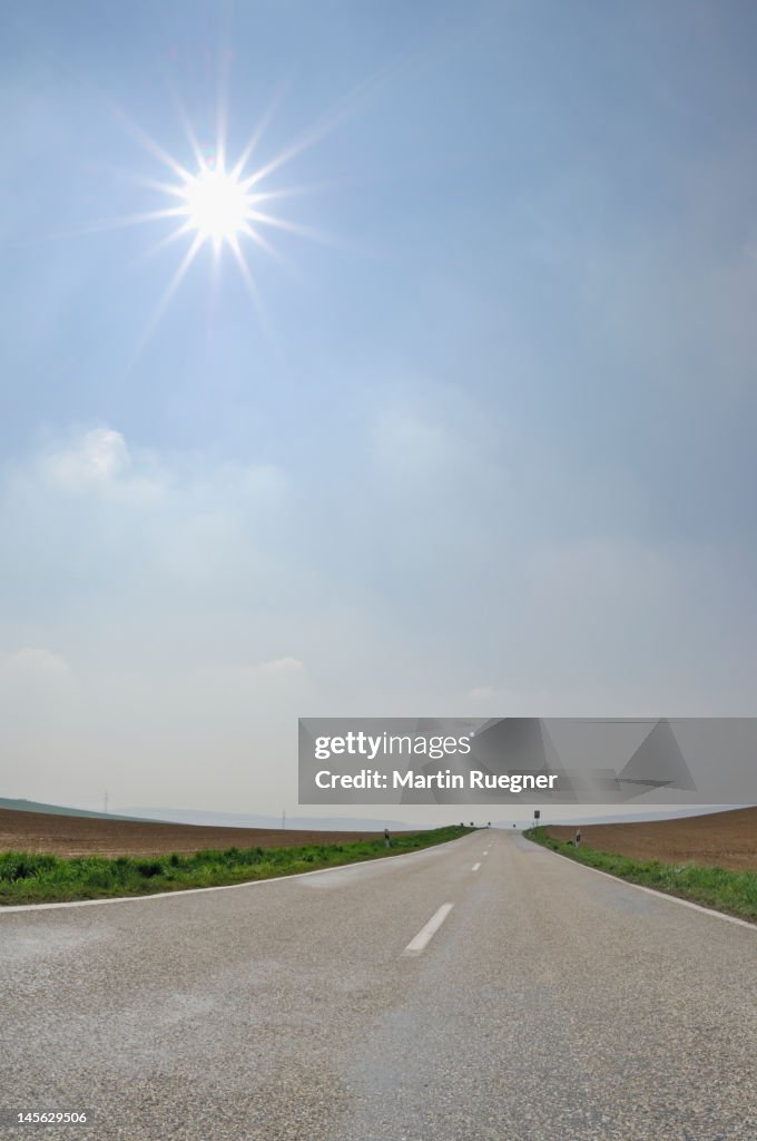 Road backlit by sun, lensflare