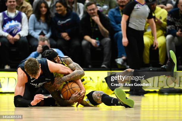 Jordan Clarkson of the Utah Jazz dives for the ball with Moritz Wagner of the Orlando Magic during the second half of a game at Vivint Arena on...