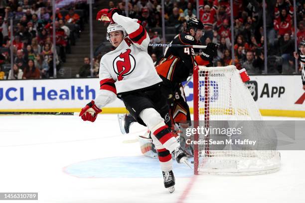 Jack Hughes of the New Jersey Devils reacts after scoring a goal as Cam Fowler of the Anaheim Ducks looks on during the third period of a game at...