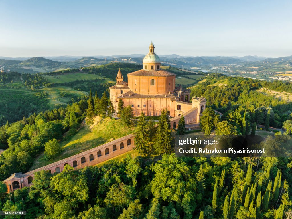 Aerial Drone Sunrise Scene of Sanctuary of the Madonna di San Luca chapel existed on the hill for about a thousand years with a road now leads up to the sanctuary, it along a 3.8 km monumental roofed arcade (Portico di San Luca) consisting of 666 arches