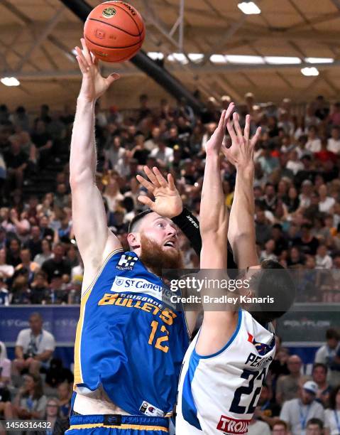 Aron Baynes of the Bullets takes on the defence of Mason Peatling of United during the round 15 NBL match between Brisbane Bullets and Melbourne...