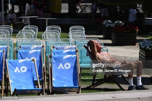 Visitor sits on a deckchair and enjoys the extreme heat in Garden Square ahead of the 2023 Australian Open at Melbourne Park on January 14, 2023 in...