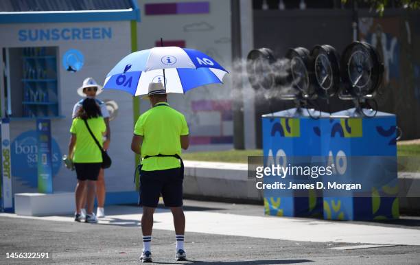 Staff try to keep cool in the extreme heat ahead of the 2023 Australian Open at Melbourne Park on January 14, 2023 in Melbourne, Australia.