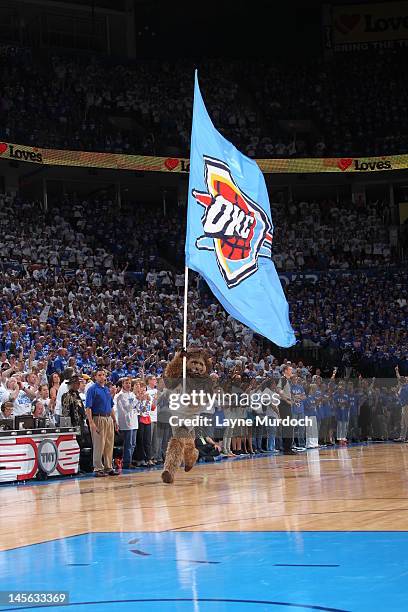 The Oklahoma City Thunder mascot carries the Oklahoma City Thunder flag on court in Game Four of the Western Conference Finals between the San...