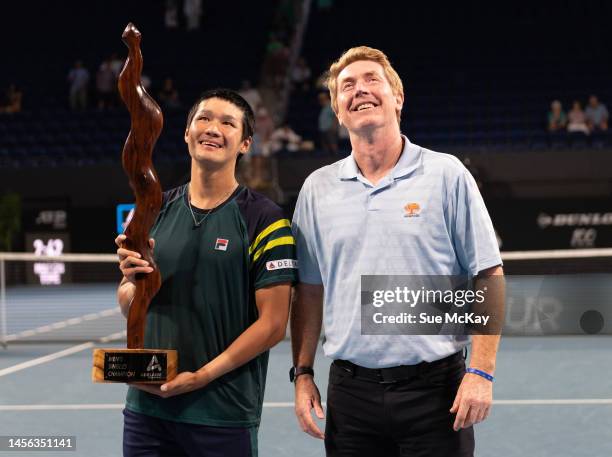 Men's single champion Kwon Soon-woo of South Korea holds the trophy as he poses with Mark Woodforde during the presentation ceremony after the men's...