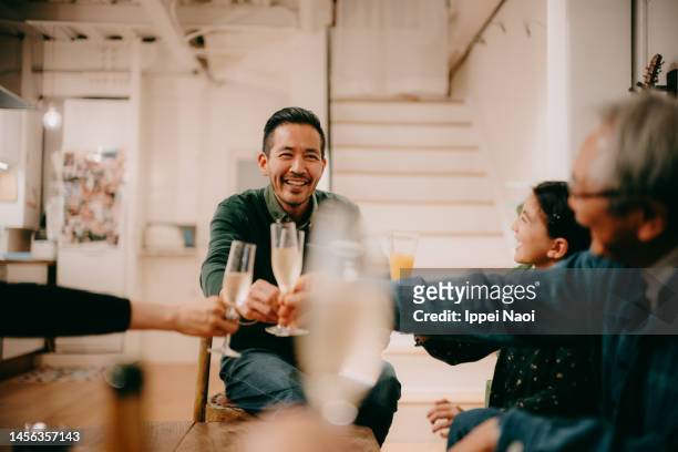 cheerful man toasting with family - 飲み会　日本 ストックフォトと画像