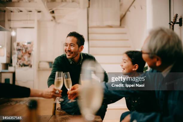 cheerful man toasting with family - aperitif stock-fotos und bilder