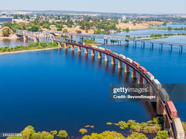 aerial view, container freight train crossing inundated floodplain on elevated railway track, murray river, south australia - 澳洲南部 個照片及圖片檔