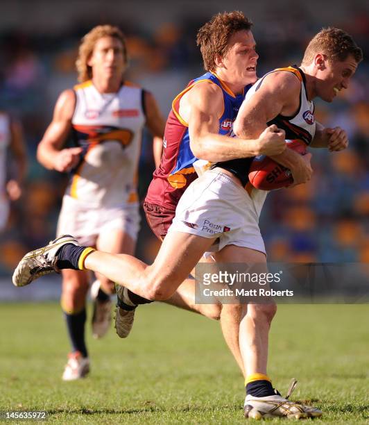 Adam Selwood of the Eagles is tackled by Jared Polec of the Lions during the round 10 AFL match between the Brisbane Lions and the West Coast Eagles...