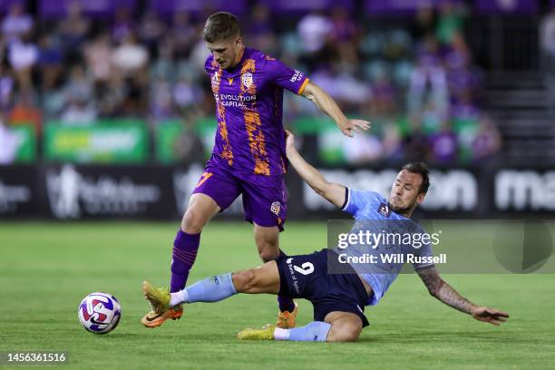 Jacob Muir of the Glory is tackled by Adam Le Fondre of Sydney FC during the round 12 A-League Men's match between Perth Glory and Sydney FC at...