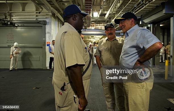 Secretary of Defense Leon Panetta speaks to members of the crew with USNS Byrd Ship Master Captain John Sargent as he visits USNS Byrd on June 3,...