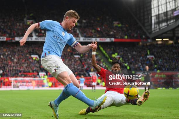 Kevin De Bruyne of Manchester City passes while under pressure from Fred of Manchester United during the Premier League match between Manchester...