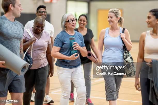 making friends at yoga class - seniors exercising stock pictures, royalty-free photos & images