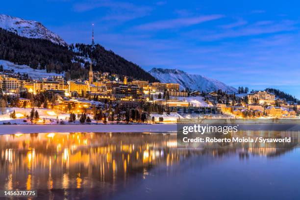 frozen lake of saint moritz at dusk in winter, switzerland - saint moritz stock-fotos und bilder