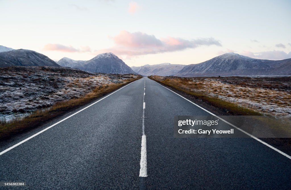 Road leading into the distance in Scottish Highland winter landscape