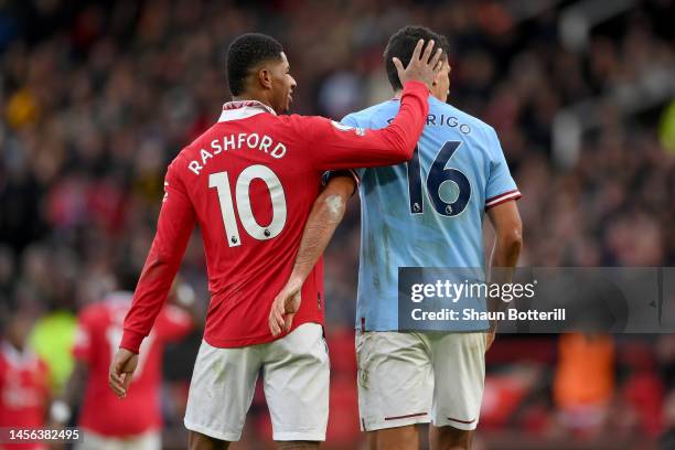 Marcus Rashford of Manchester United embraces Rodri of Manchester City during the Premier League match between Manchester United and Manchester City...