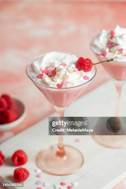 pink milkshake drink cocktail with sugar hearts and whipped cream for valentines day with raspberry - confetti bildbanksfoton och bilder