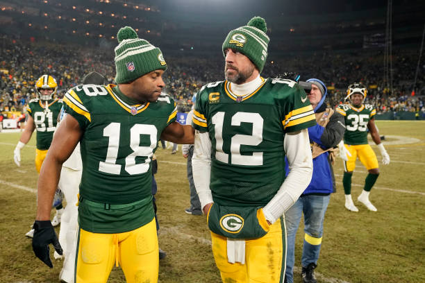 Aaron Rodgers and Randall Cobb of the Green Bay Packers walk off the field after losing to the Detroit Lions at Lambeau Field on January 08, 2023 in...