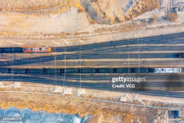 Trains loaded with coal ready to leave a coal mine belonging to China Energy Investment Corporation on January 14, 2023 in Ejin Horo Banner, Ordos...