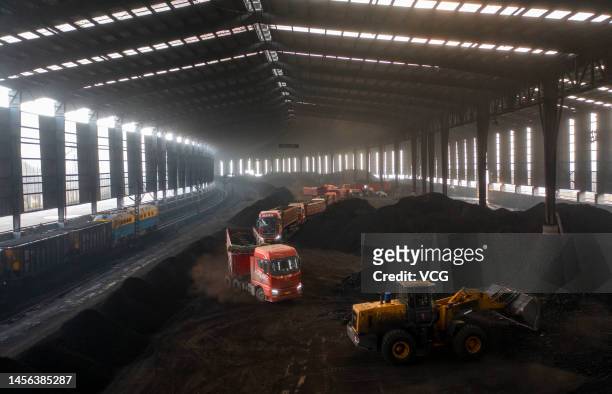 Trucks line up to transport coal at a coal mine belonging to China Energy Investment Corporation on January 14, 2023 in Ejin Horo Banner, Ordos City,...