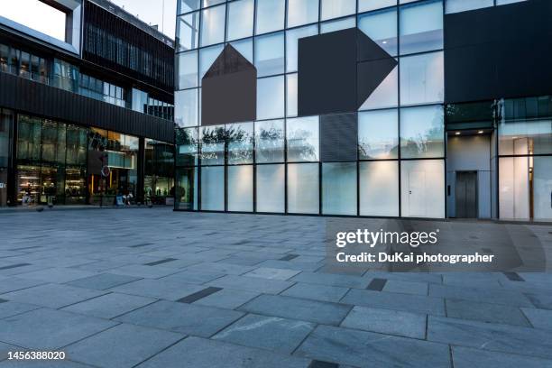 financial city square night - glass building road stockfoto's en -beelden