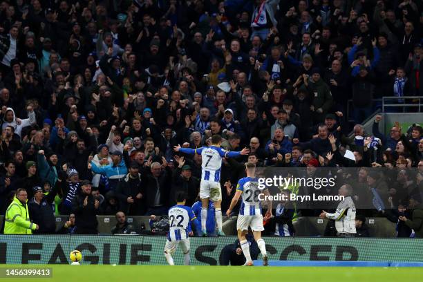 Solly March of Brighton & Hove Albion celebrates with teammates Kaoru Mitoma and Evan Ferguson of Brighton & Hove Albion after scoring the team's...